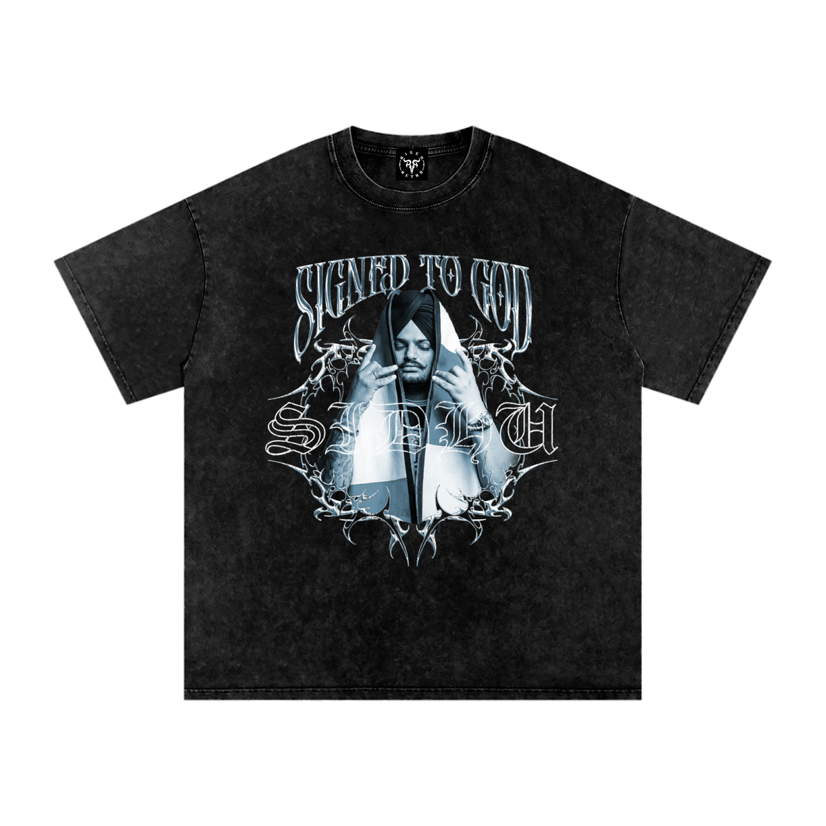 A black acid-wash graphic t-shirt featuring a gothic-style print of a hooded figure with the text 'SIGNED TO GOD' and 'STILL' in a silver metallic font.