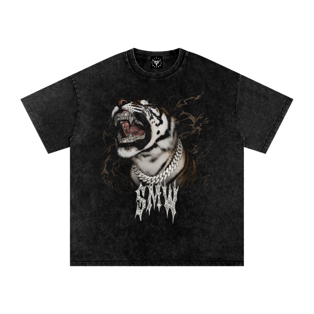 A black acid-wash graphic t-shirt featuring a roaring tiger wearing a gold chain necklace with the word 'MADNESS' in a dripping font below it, displayed flat against a white background.