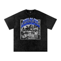 A black mineral-wash short-sleeve t-shirt featuring a large graphic print on the front with the text 'Saga of the Barbarians' in blue and a grayscale historical illustration.