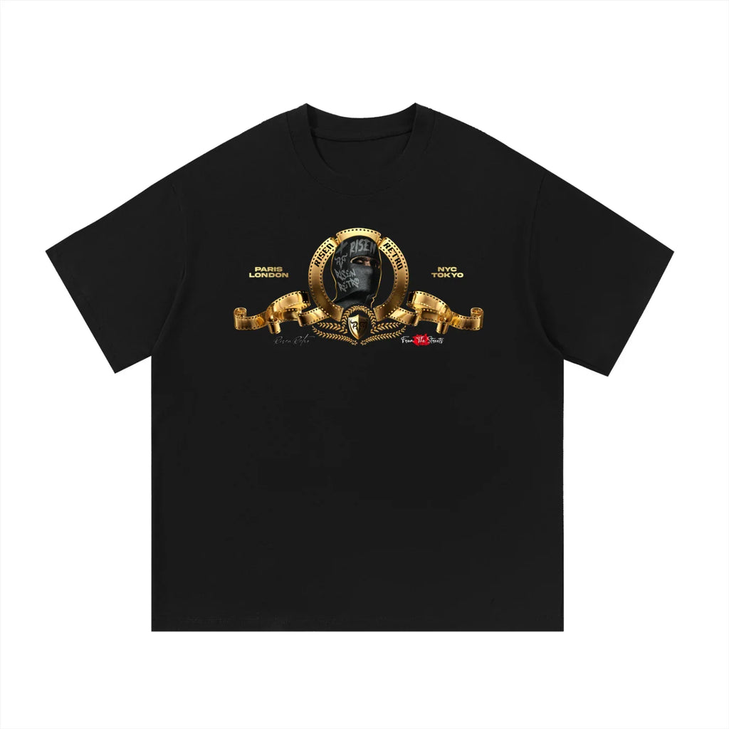 Black oversized streetwear t-shirt with gold film reel, hooded figure, and city names graphic.