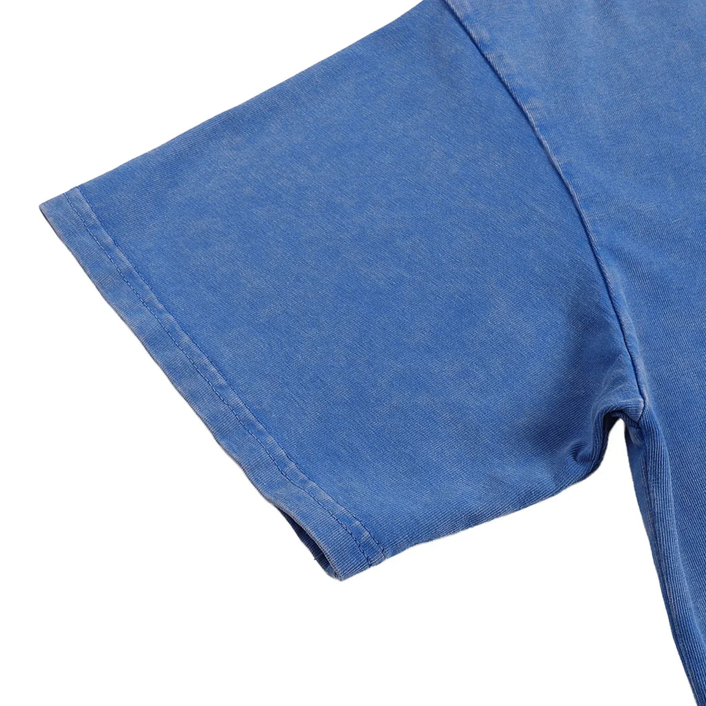 Close-up of a blue t-shirt sleeve on a white background