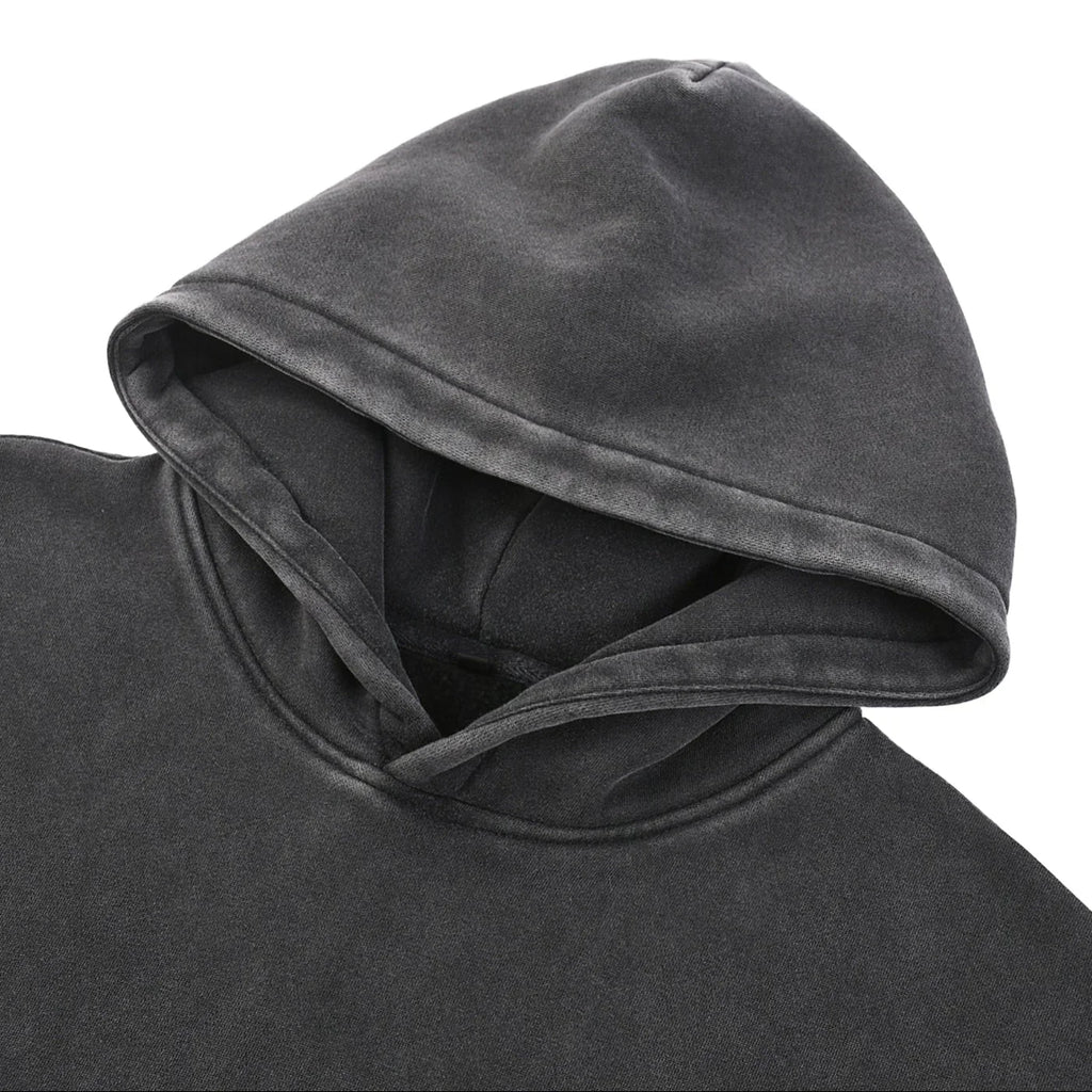 Close-up of a dark gray hooded garment on a white background