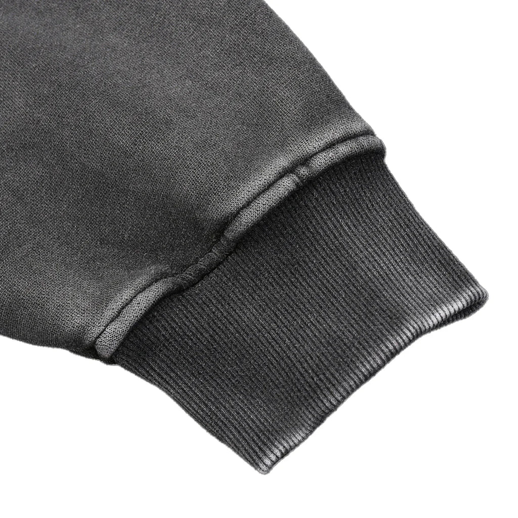 Close-up of a dark gray sweatshirt sleeve on a white background